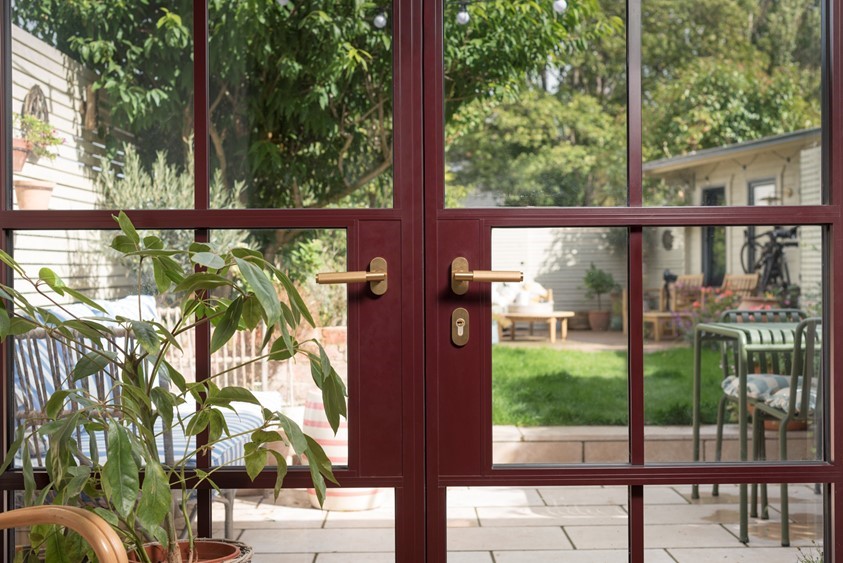 red-aluminium-french-doors-with-brass-door-furniture